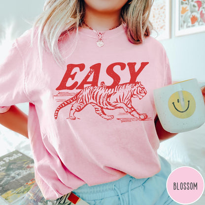 Comfort Colors tee in Blossom featuring vintage style graphic of a walking tiger and text Easy