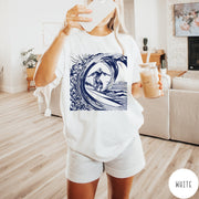 Comfort Colors tee in White featuring graphic style Jesus surfing on a large ocean wave