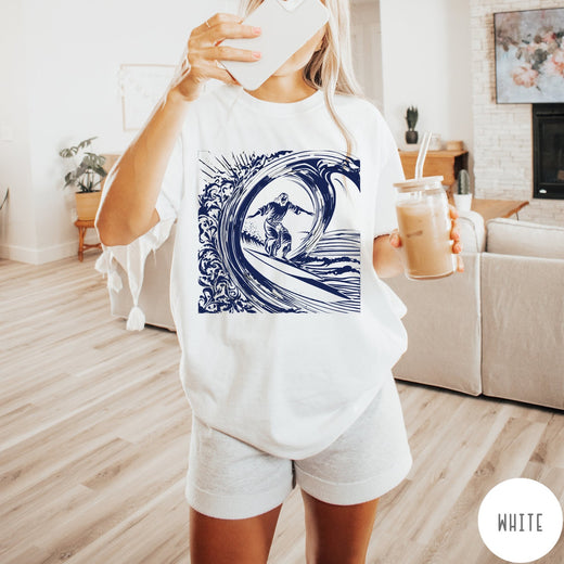 Comfort Colors tee in White featuring graphic style Jesus surfing on a large ocean wave