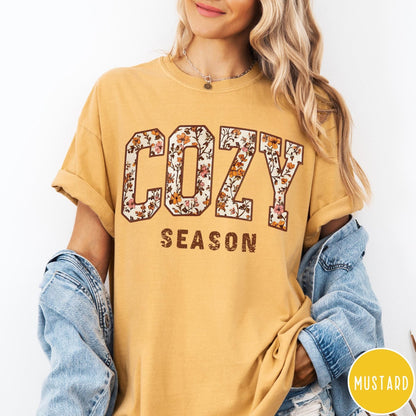 Comfort Colors tee in Mustard featuring autumnal floral typography with a cozy season graphic design