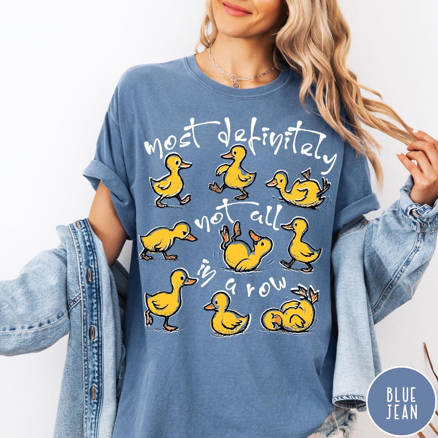 Comfort Colors tee in Blue Jean featuring screen print style graphic of nine yellow ducks in various poses