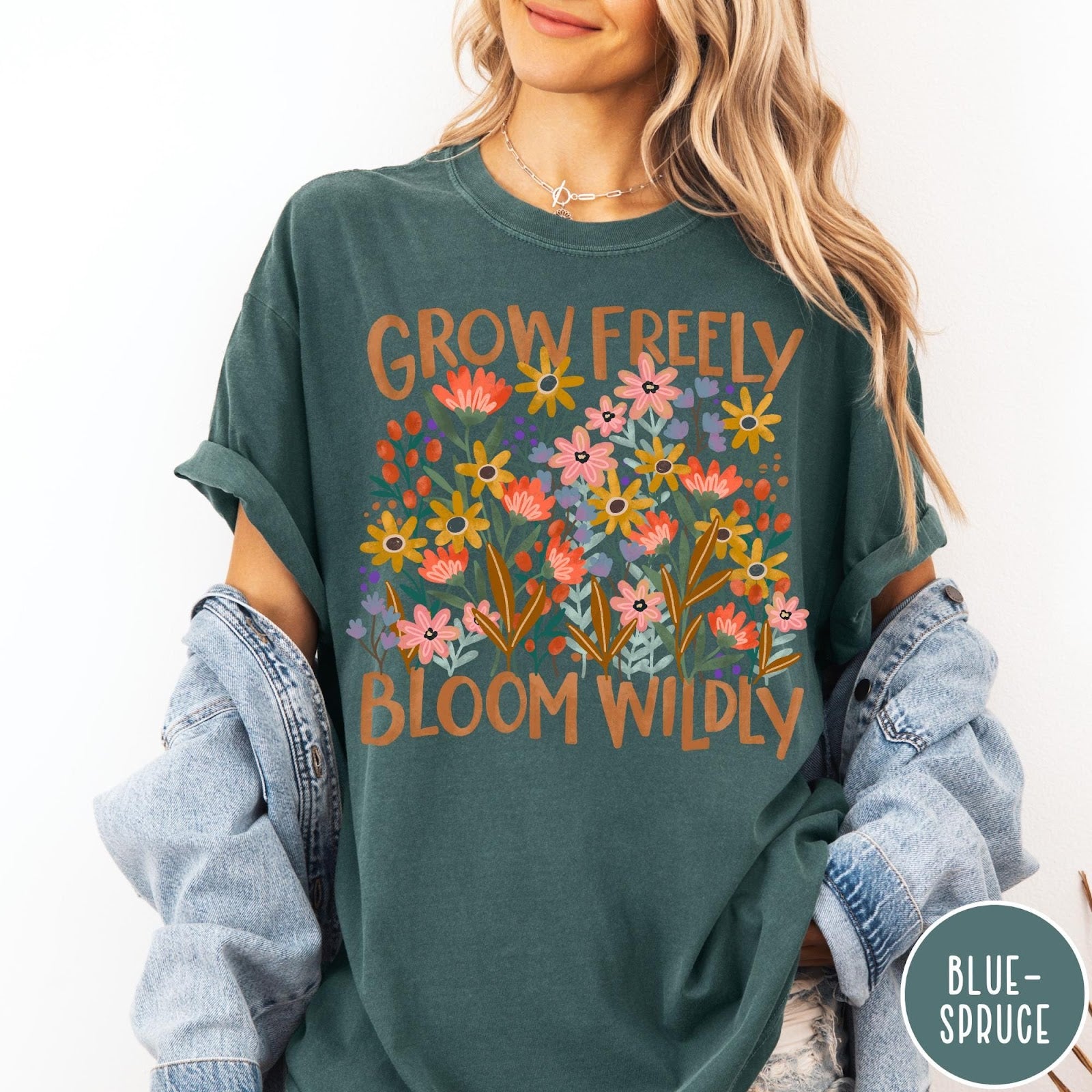 Comfort Colors tee in Blue Spruce featuring wildflower design with text Grow Freely Bloom Wildly in earthy tones