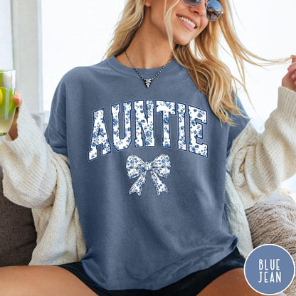 Comfort Colors tee in Blue Jean featuring floral bow graphic with the word Auntie in blue floral print
