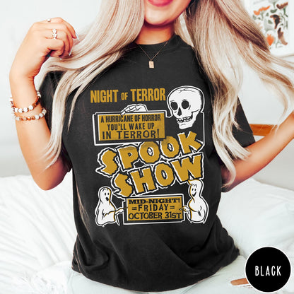 Comfort Colors tee in Black featuring retro horror movie poster graphic with skull and spooky ghost illustrations