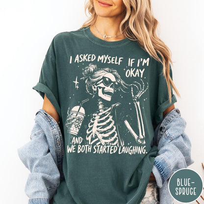 Comfort Colors tee in Blue Spruce featuring skeleton design with sunglasses and iced coffee with laughing text graphic
