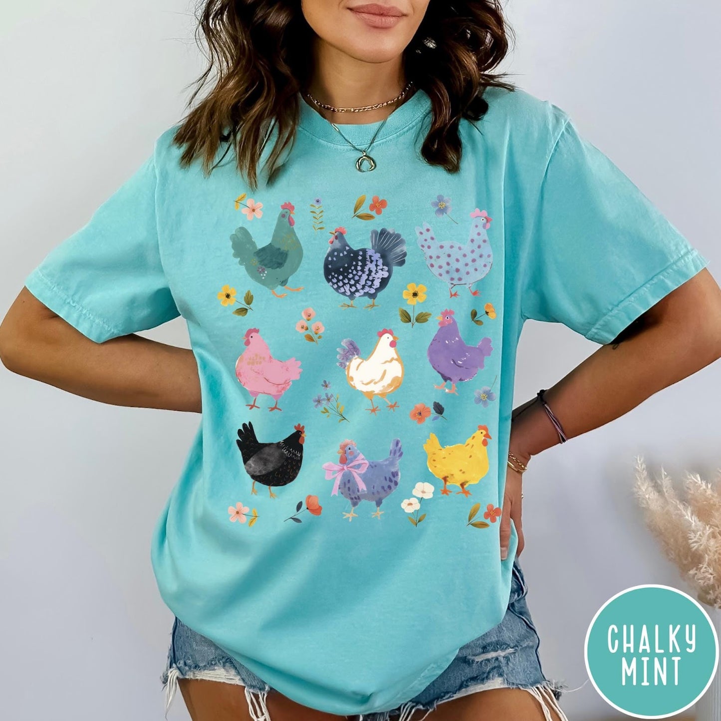 Comfort Colors tee in Chalky Mint featuring vintage style graphic with various colorful chickens and small floral accents