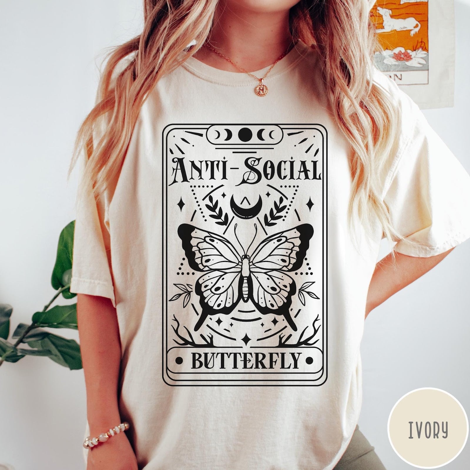 Comfort Colors tee in Ivory featuring tarot card style graphic with butterfly and celestial moon phase design