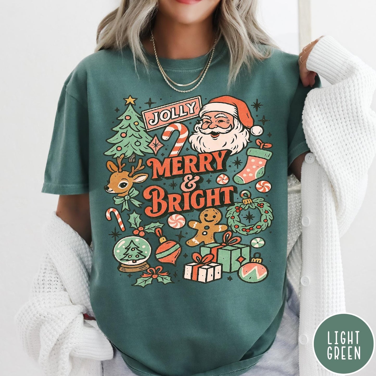 Comfort Colors tee in Light Green featuring retro holiday design with Santa, reindeer, and Christmas icons.