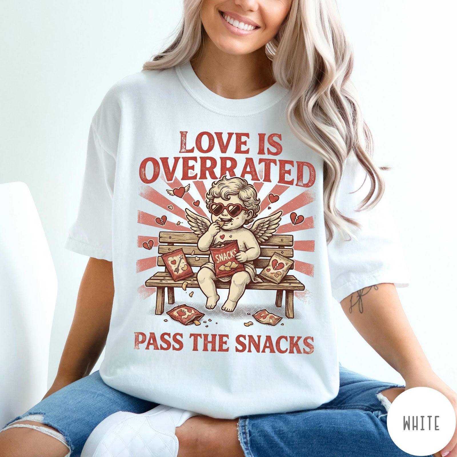 Comfort Colors tee in White featuring vintage style graphic of a cherub eating snacks on a bench