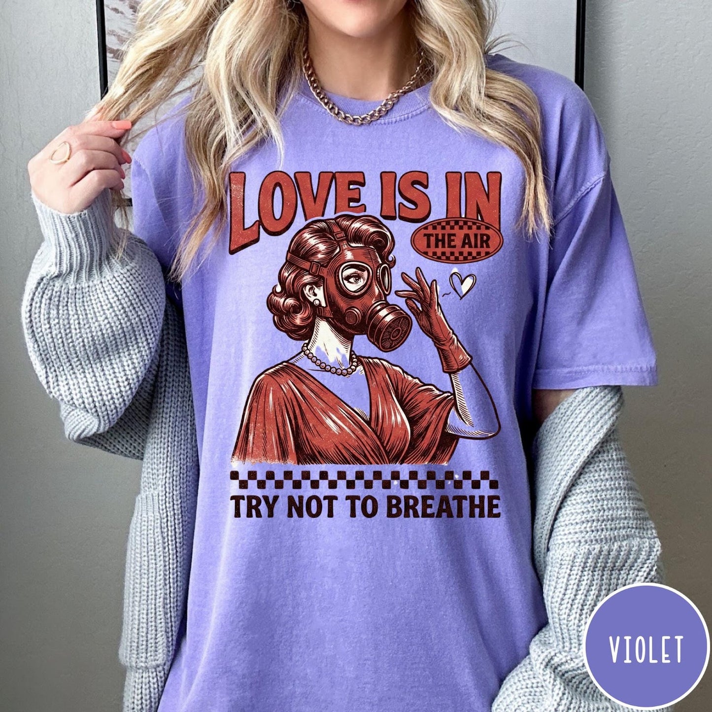 Comfort Colors tee in Violet featuring retro style graphic of a woman wearing a gas mask