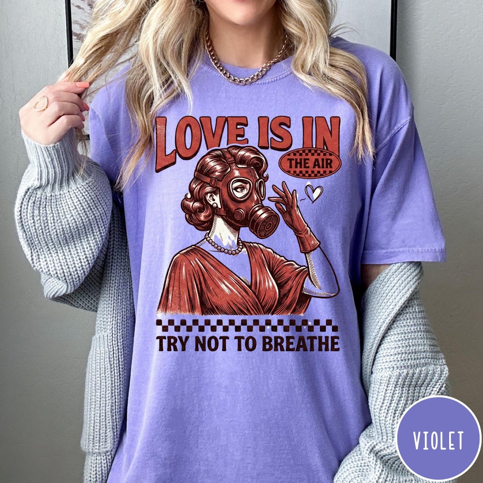 Comfort Colors tee in Violet featuring retro style graphic of a woman wearing a gas mask
