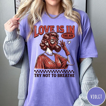 Comfort Colors tee in Violet featuring retro style graphic of a woman wearing a gas mask
