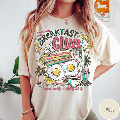 Comfort Colors tee in Ivory featuring breakfast food graphic with bacon, eggs, coffee, and palm trees.