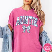 Comfort Colors tee in Crunchberry featuring floral bow graphic with the word Auntie in blue floral print