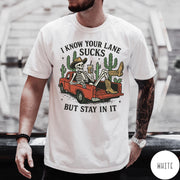 Comfort Colors tee in White featuring western skeleton graphic with cowboy hat and boots in pickup truck