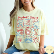 Comfort Colors tee in Butter featuring baseball icons including bats, a glove, stadium, and trophy graphic design