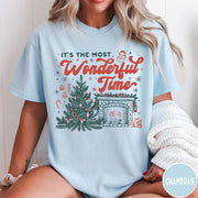 Comfort Colors tee in Chambray featuring Christmas design with a decorated tree and a cozy fireplace scene