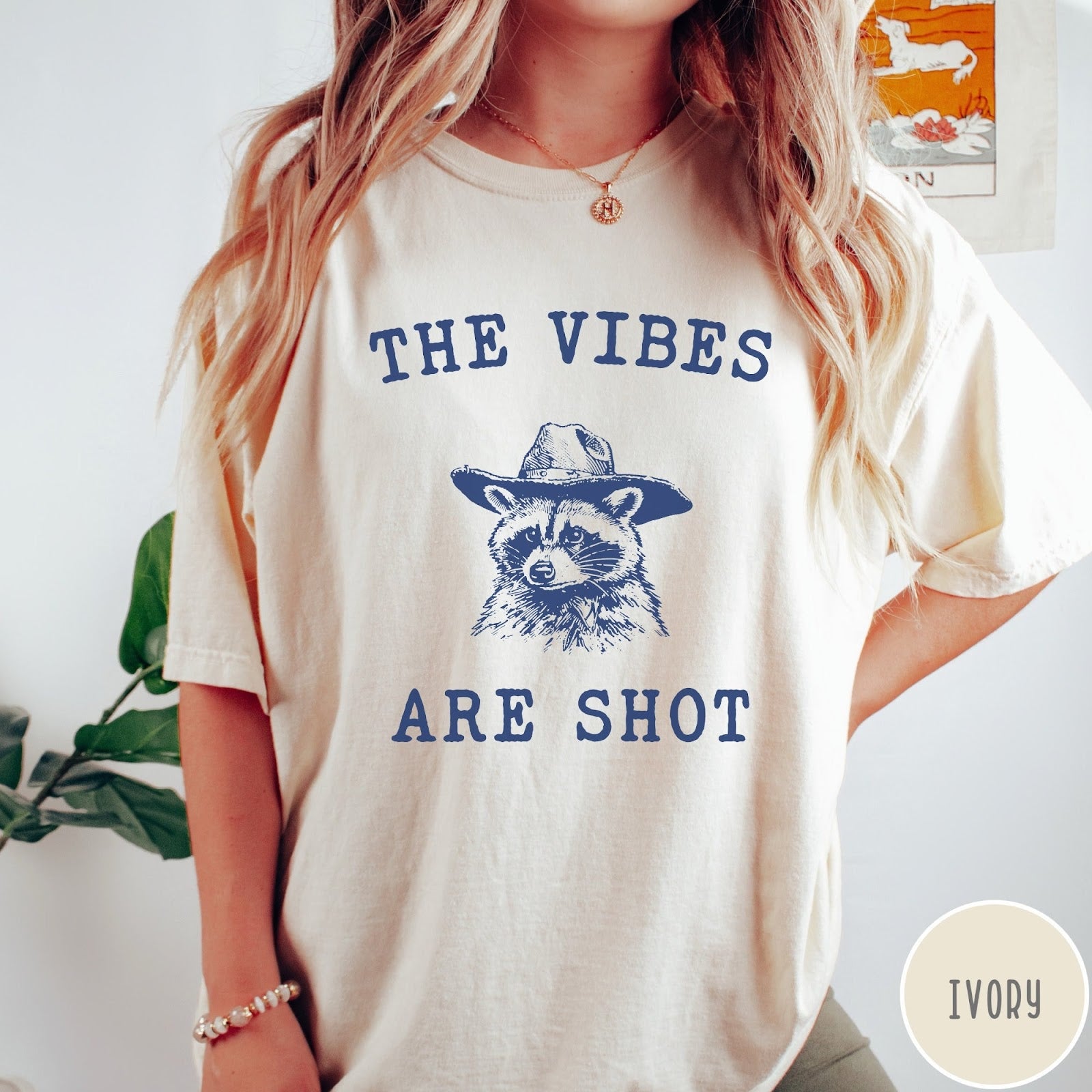Comfort Colors tee in Ivory featuring graphic style raccoon wearing a cowboy hat and text The Vibes Are Shot