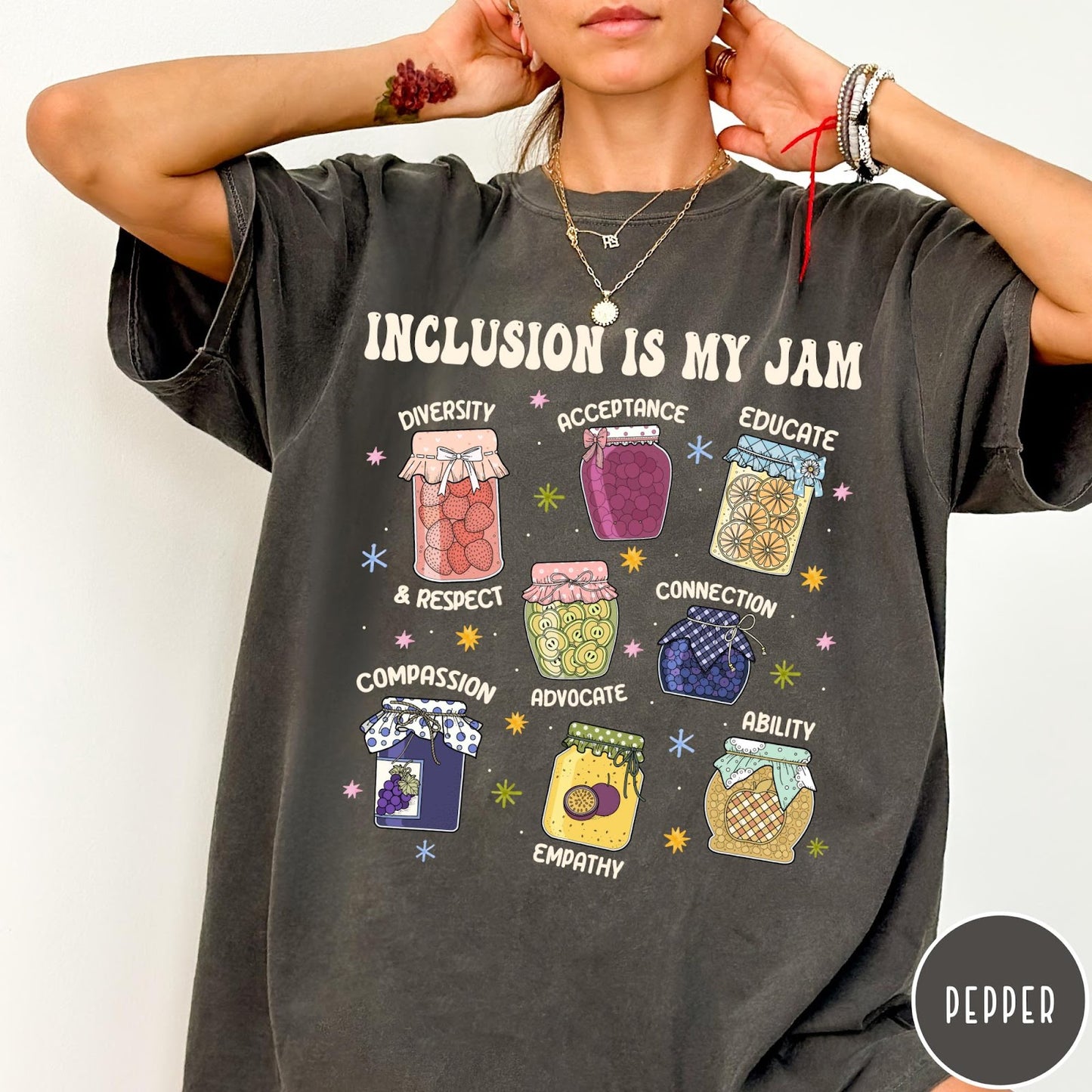 Comfort Colors tee in Pepper featuring retro style graphic with jam jars labeled with inclusion and advocacy terms