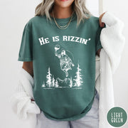 Comfort Colors tee in Light Green featuring graphic style Jesus playing basketball with mountains and pine trees illustration