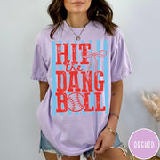 Comfort Colors tee in Orchid featuring baseball design with red text and a blue striped background graphic