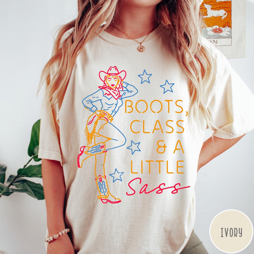 Comfort Colors tee in Ivory featuring retro cowgirl design with boots and text Boots, Class & A Little Sass
