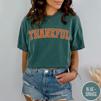 Comfort Colors tee in Blue Spruce featuring typography graphic with the word Thankful in an arched varsity style