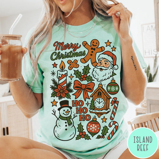 Comfort Colors tee in Island Reef featuring retro holiday design with Christmas icons like Santa and a snowman