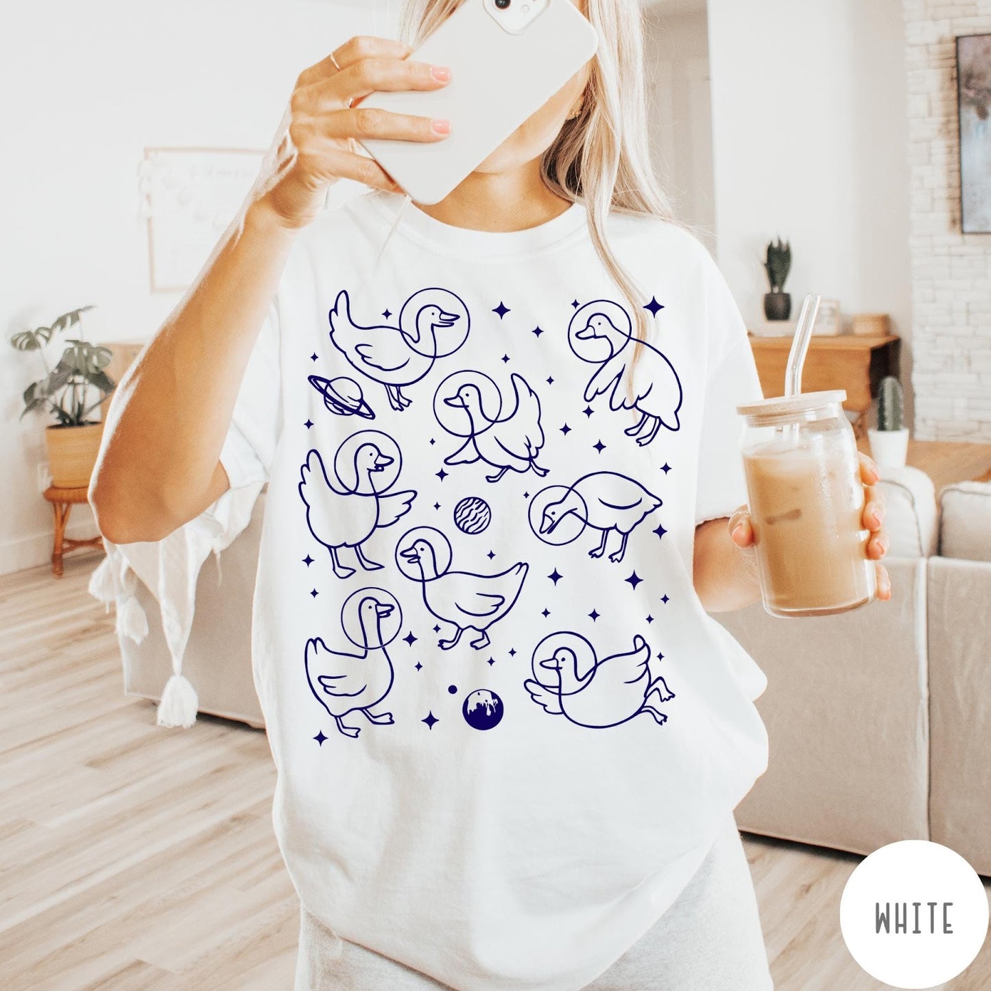 Comfort Colors tee in White featuring line art graphic of multiple geese wearing astronaut helmets in space