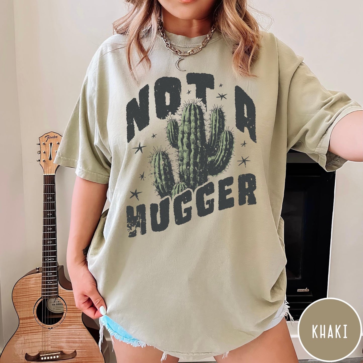 Comfort Colors tee in Khaki featuring cactus graphic and Not a Hugger text with small stars