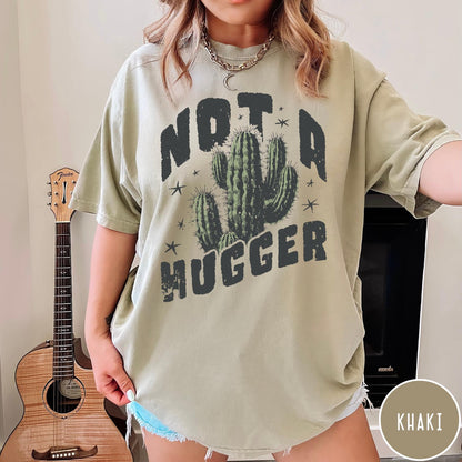 Comfort Colors tee in Khaki featuring cactus graphic and Not a Hugger text with small stars