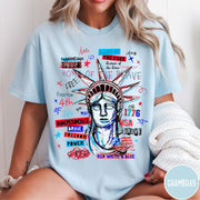 Comfort Colors tee in Chambray featuring grunge style Statue of Liberty graphic with patriotic red and blue text