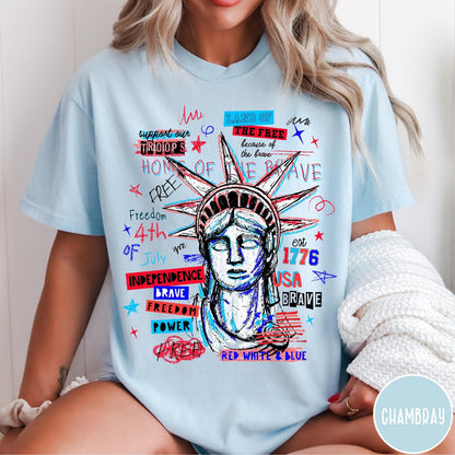 Comfort Colors tee in Chambray featuring grunge style Statue of Liberty graphic with patriotic red and blue text
