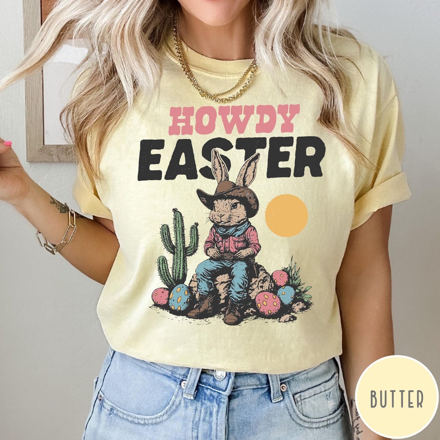 Comfort Colors tee in Butter featuring western design style cowboy bunny sitting on a rock with cactus
