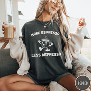 Comfort Colors tee in Pepper featuring retro style graphic of a happy coffee cup with text