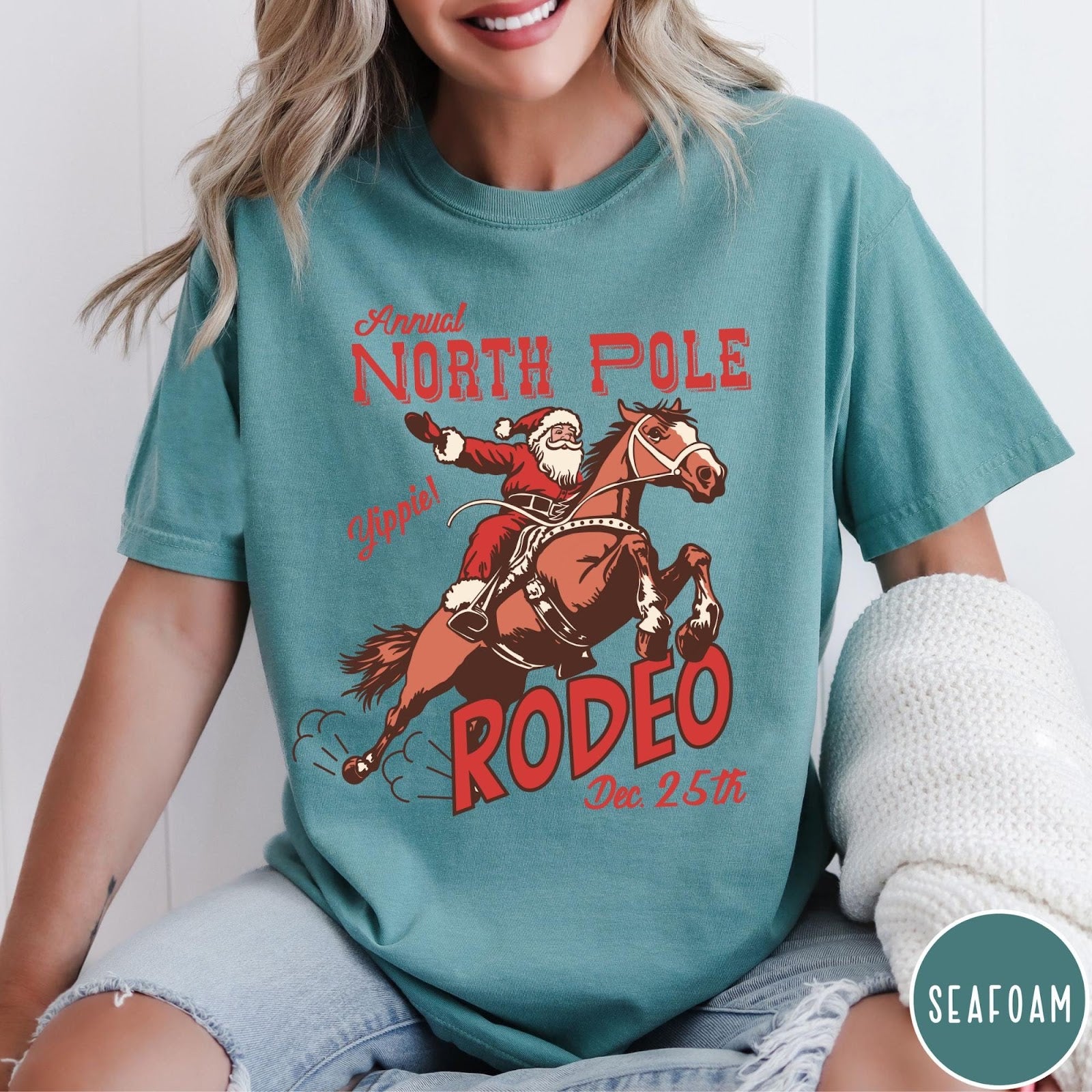 Comfort Colors tee in Seafoam featuring vintage style graphic of Santa Claus riding a bucking rodeo horse