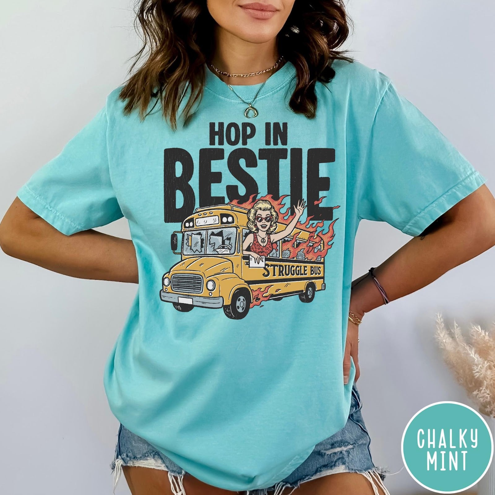 Comfort Colors tee in Chalky Mint featuring retro style graphic of a woman waving from a burning school bus