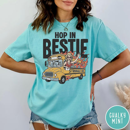 Comfort Colors tee in Chalky Mint featuring retro style graphic of a woman waving from a burning school bus