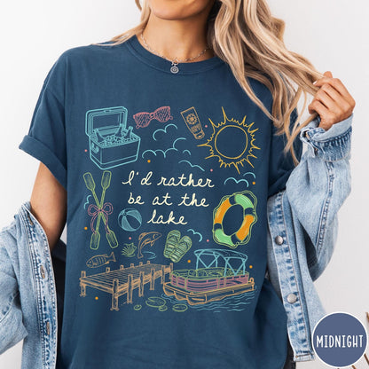 Comfort Colors tee in Midnight featuring lake vacation graphic with pontoon boat, dock, and summer accessories