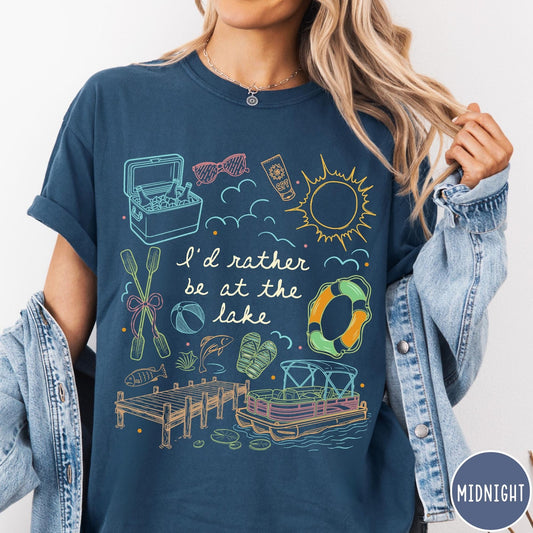 Comfort Colors tee in Midnight featuring lake vacation graphic with pontoon boat, dock, and summer accessories