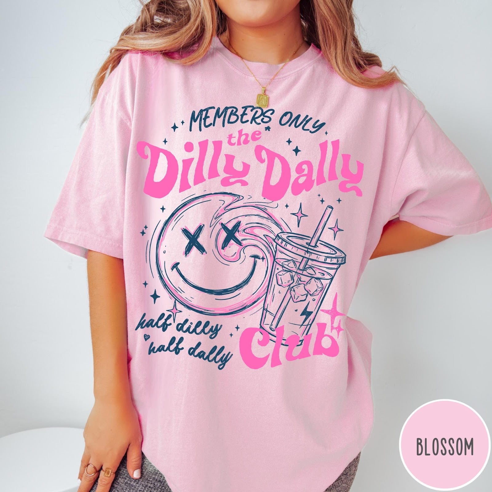 Comfort Colors tee in Blossom featuring Dilly Dally Club graphic with smiley face and iced coffee cup