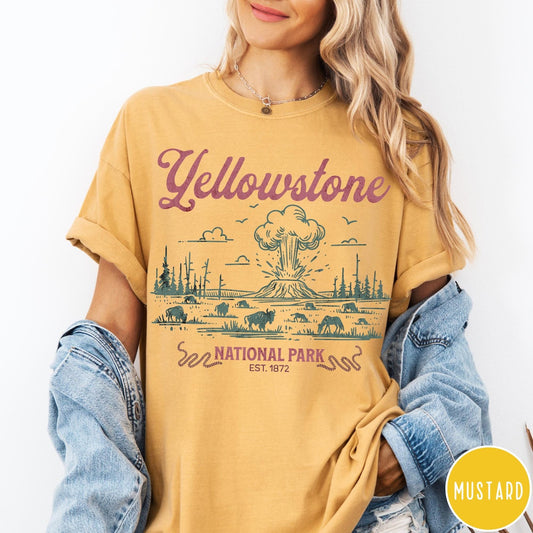 Comfort Colors tee in Mustard featuring retro graphic design of Yellowstone National Park with bison and geyser