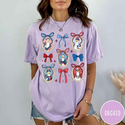 Comfort Colors tee in Orchid featuring coquette design with patriotic geese in frames and bows