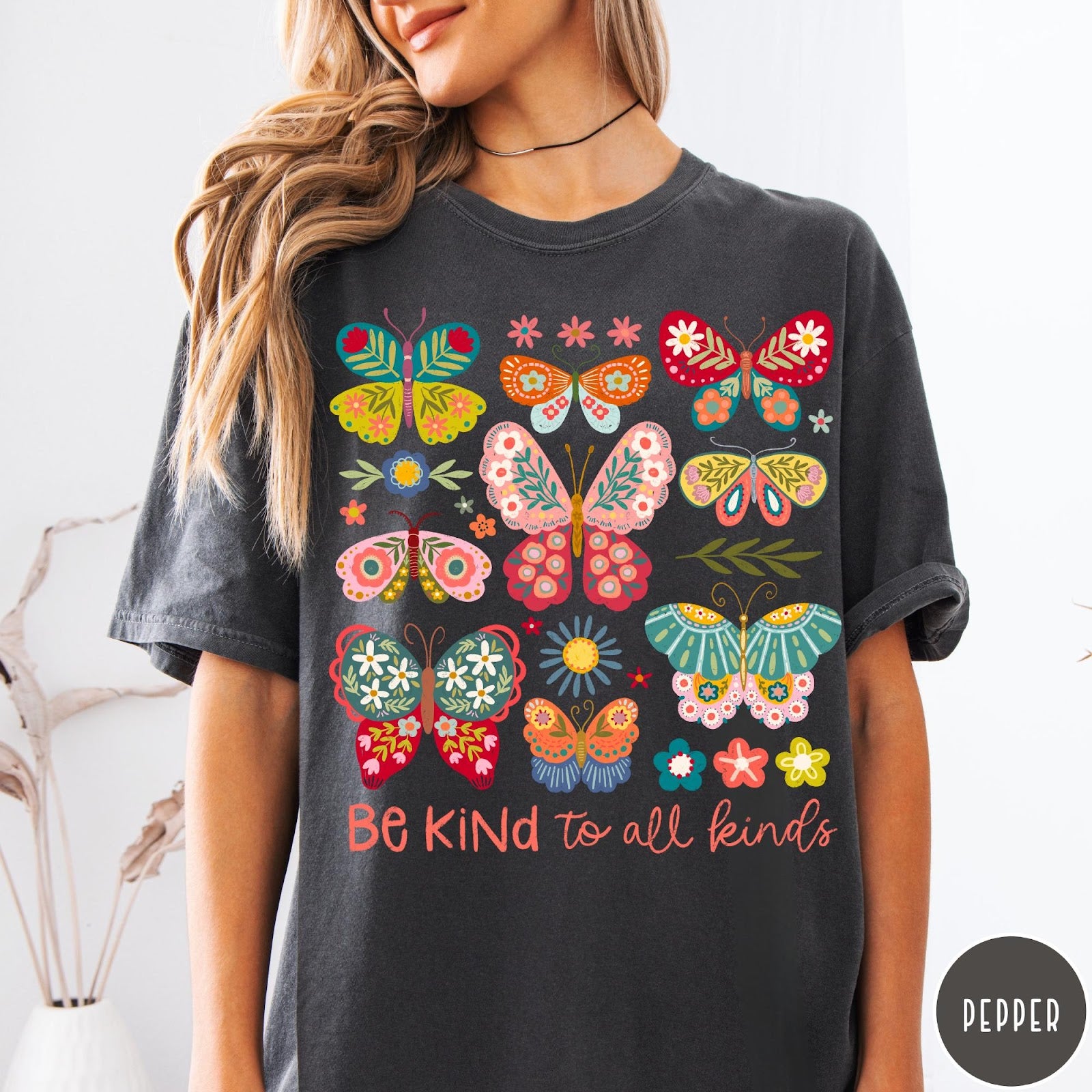 Comfort Colors tee in Pepper featuring colorful butterfly and floral graphic with Be Kind to all kinds text