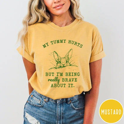 Comfort Colors tee in Mustard featuring line art graphic of a bunny with text My Tummy Hurts