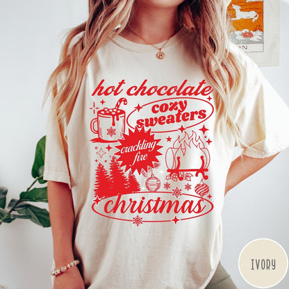 Comfort Colors tee in Ivory featuring holiday graphic design with hot chocolate, fire, and Christmas trees