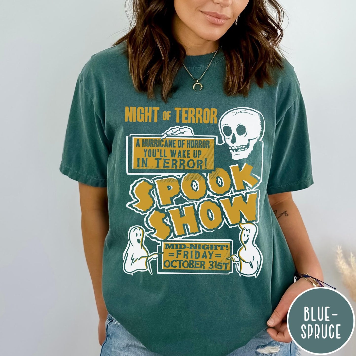 Comfort Colors tee in Blue Spruce featuring retro horror movie poster graphic with skull and spooky ghost illustrations