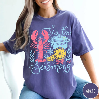 Comfort Colors tee in Grape featuring lobster boil graphic with lobster, pot, and lemon slices