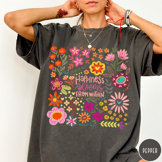 Comfort Colors tee in Pepper featuring floral wildflowers design with Happiness Blooms Within text graphic description