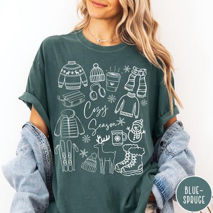 Comfort Colors tee in Blue Spruce featuring line art winter activities and seasonal items graphic design